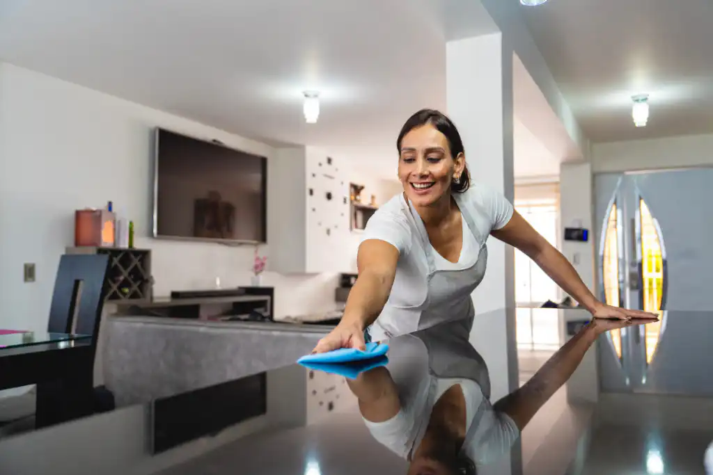 Residential cleaning team polishing a kitchen island in a Columbia Station home.